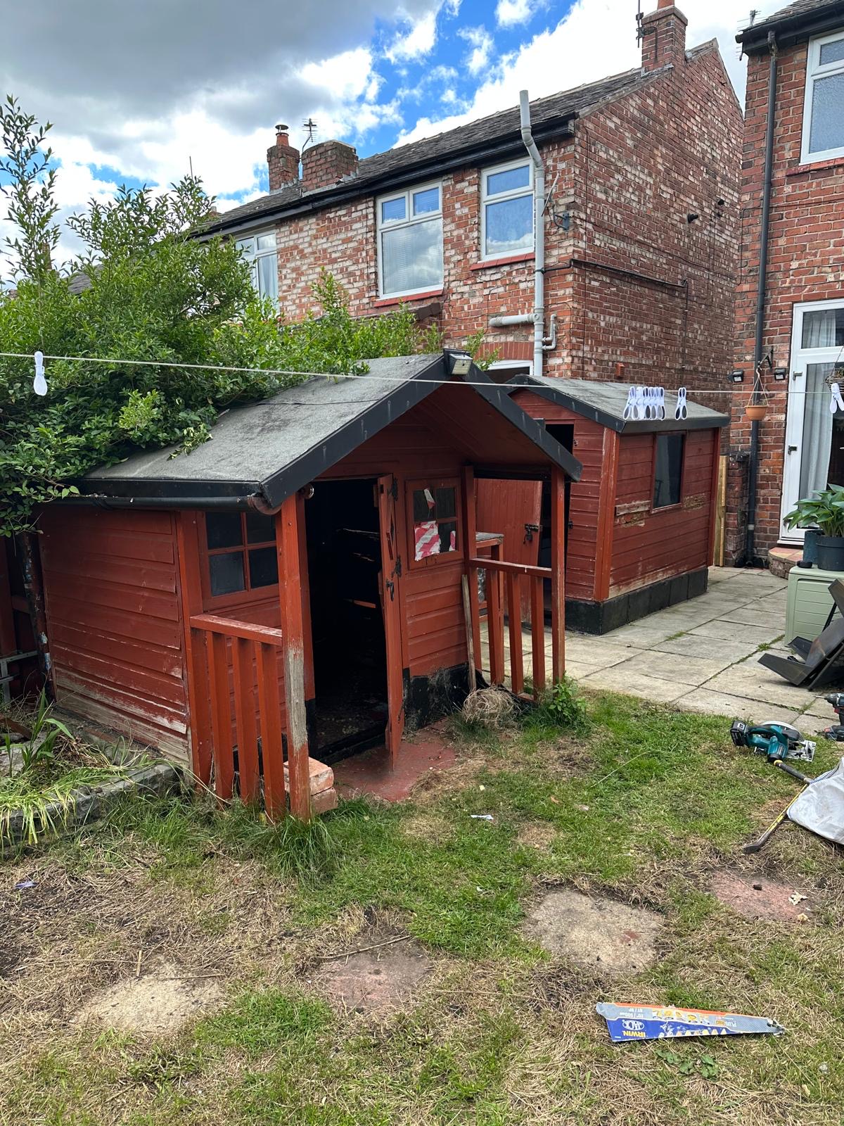 Old wooden shed standing in a Stockport back garden before Vanquish Waste dismantle and removal